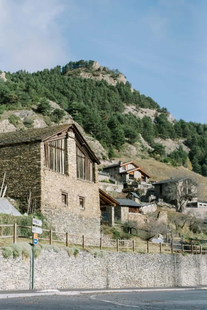 Charming hillside village with rustic stone houses on a sunny summer day.