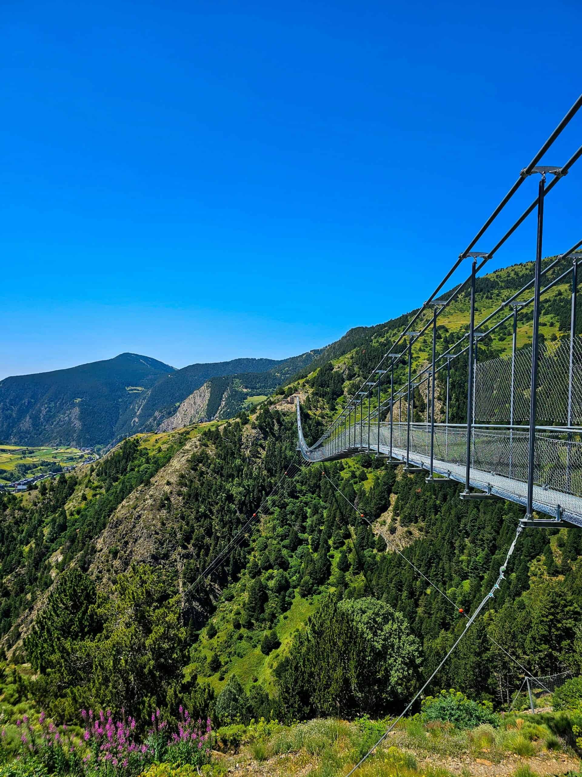 Breathtaking alpine landscape with a suspension bridge in Ordino, Andorra.